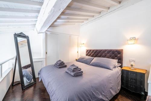 a bedroom with a bed with towels on it at Florence F&M Via Maggio in Florence