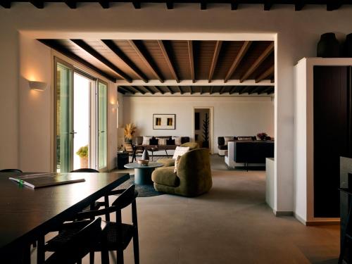 a living room with a couch and a table at Mykonos Rocks Villas & Suites in Mýkonos City