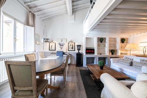 a living room with a table and a couch at Florence F&M Via Maggio in Florence