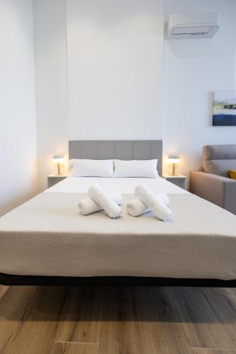 a bedroom with a bed with two towels on it at Les Arts Plaza by Concept Flats in Valencia