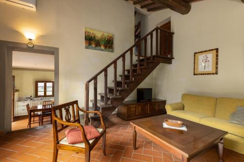 a living room with a couch and a table at Podere San Bartolo- Fienile in Barberino di Val dʼElsa