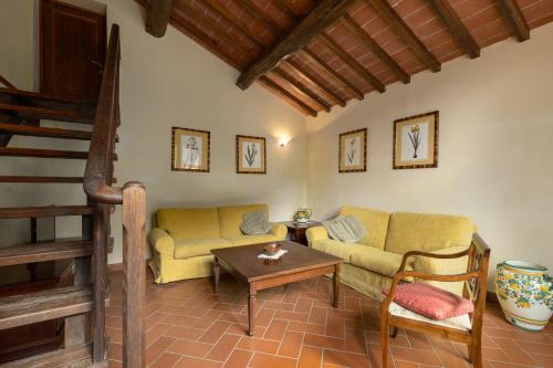 a living room with a couch and a table at Podere San Bartolo- Fienile in Barberino di Val dʼElsa