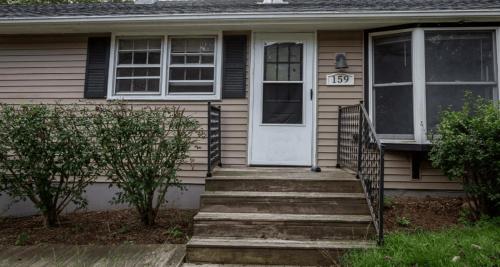 a house with a white door and stairs at Cozy 3BR Home near Casinos! in Mohegan