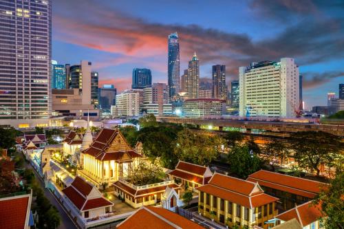 a city skyline at night with tall buildings at Banthat Thong Hostel in Bangkok