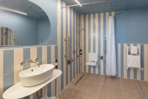 a bathroom with a sink and a shower at SeaSpace in Newquay