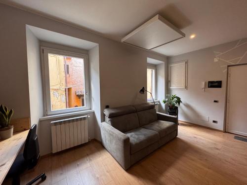 a living room with a couch and a window at La Dea Bendata in Rocca Priora