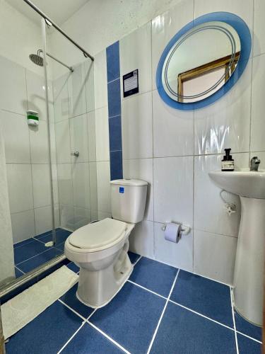 a bathroom with a toilet and a sink at Hostel Beach House in Rincón