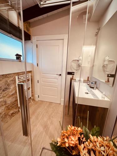 a bathroom with a sink and a mirror at La Quinta Luxury Palace in Arnuero