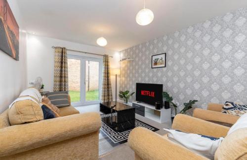 a living room with two couches and a tv at Supreme House in Middlesbrough