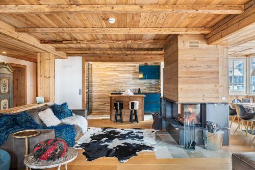 a living room with a couch and a fireplace at Haus Gabriel - Seefeld in Seefeld in Tirol