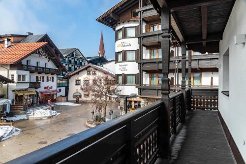 a balcony with a view of a town with buildings at Haus Gabriel - Seefeld in Seefeld in Tirol
