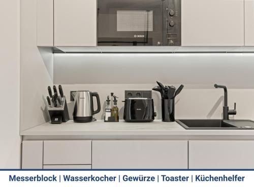 a kitchen counter with a sink and utensils at 1-2 Personen - Parkplatz - Fahrradgarage - Zentrum - Küche - Balkon - Klima in Sankt Martin