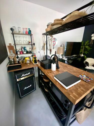 a kitchen with a desk with a laptop on it at Maisonette jacuzzi terrasse Lille in Saint-André-lez-Lille