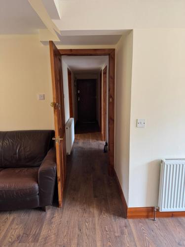 a living room with a couch and a hallway at The Retreat Hotel in Strathpeffer