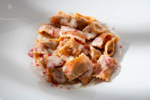 a pile of food on a white plate at Hotel la Colletta in Paesana