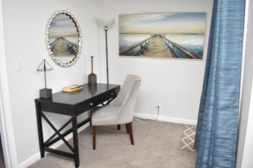 una scrivania nera con sedia e specchio di Lakefront Home with Amazing Views, Hot tub, Boat JetSki Rental Option a Lake Ozark