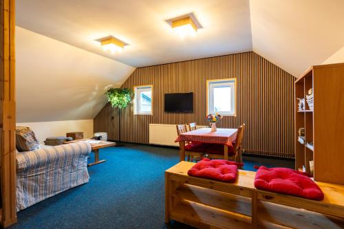 a living room with a couch and a table at Penzion Na Výšinkách, Jetřichovice, České Švýcarsko in Jetřichovice