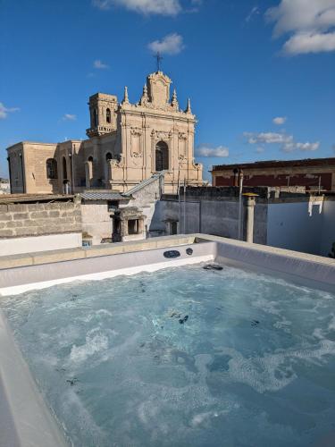 a pool of water with a building in the background at Casa Vacanze con Piscina a 2 passi da Lecce P1 in San Pietro in Lama