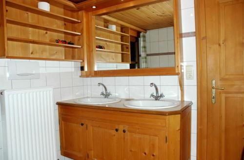 a bathroom with two sinks and a mirror at Ferienhaus Dünser In Dünserberg in Bürserberg