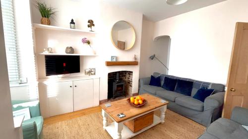a living room with a couch and a table at Seascape Luxury Cottage Southwold - Free Parking in Reydon