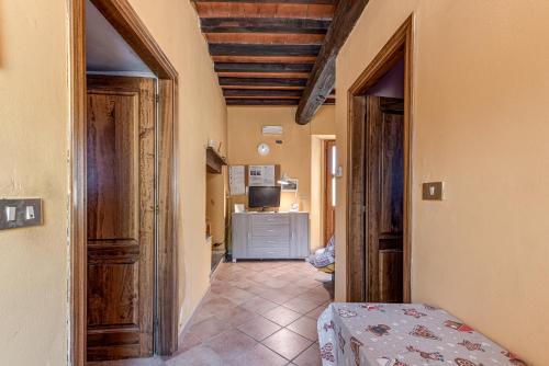 a hallway with a room with a bed and a television at Agriturismo Il Ponte - Frantoio in Vicchio