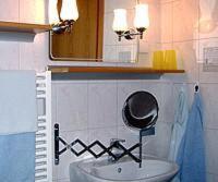 a bathroom with a sink and a mirror at Hotel-Pension Märkischheide in Vetschau