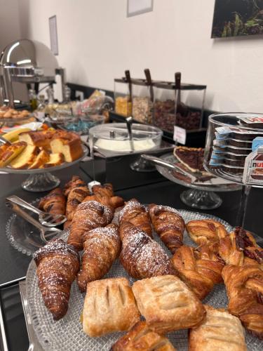 a buffet of pastries and breads on a table at Al Santuario di Fiorano Charming Hostel in Fiorano Modenese