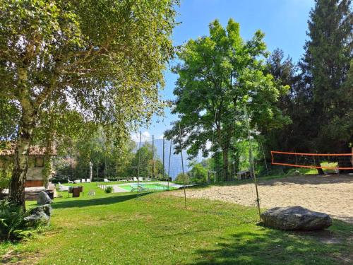 a park with a volleyball net in the grass at Hotel Mirabeau in Bellagio