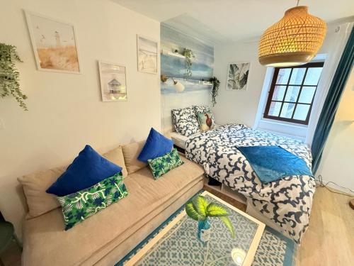 un salon avec un canapé et un lit dans l'établissement Cosy Azur & Corail ! 2CH Proche de Verdun, à Pau
