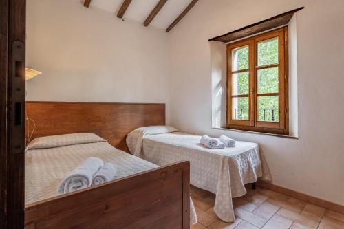 a bedroom with two beds and a window at Piamperugino in Arcidosso