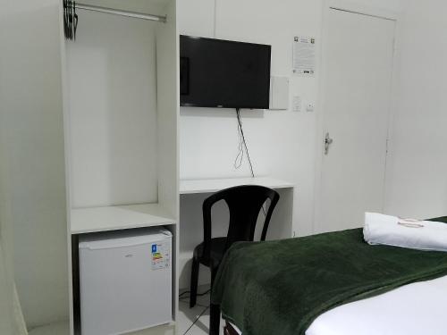 TV a/nebo společenská místnost v ubytování Hotel Aconchegante