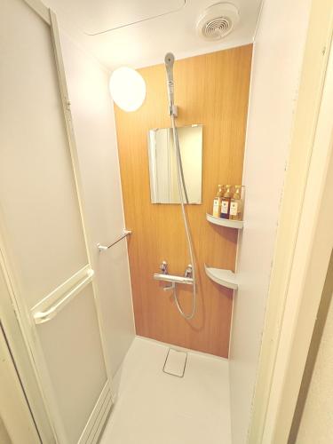 a bathroom with a shower and a toilet at 和の宿ホテルYamatoinn Akihabara#101 in Tokyo
