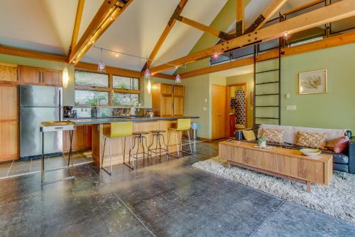 a kitchen and living room with a couch and a table at Driftwood Retreat in Anacortes