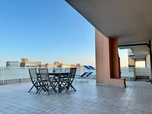 a table and chairs on the roof of a building at 82, Attico Leonardo in Lido Adriano