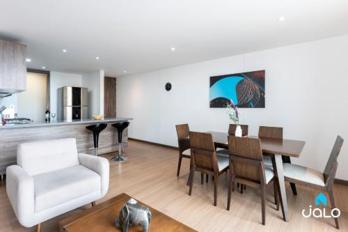 a kitchen and living room with a table and chairs at 72Hub Apartments By Jalo in Bogotá