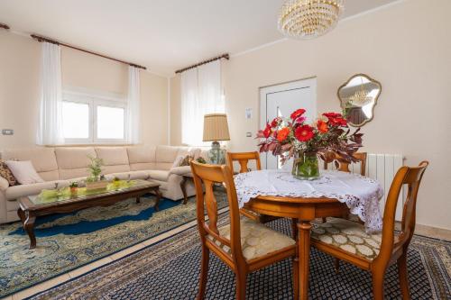 a living room with a table with a vase of flowers on it at Sara in Zagorje