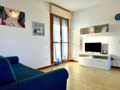 a living room with a couch and a television at 82, Attico Leonardo in Lido Adriano