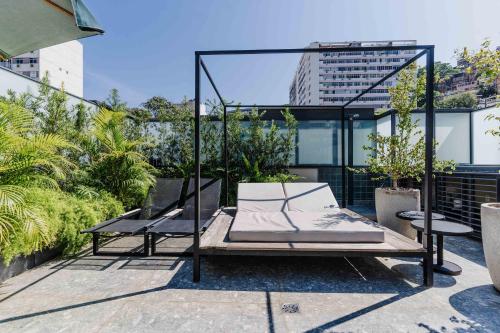 a bed and two chairs on top of a building at OBO Casa • Modern Lux Design Loft • Ipanema Beach in Rio de Janeiro