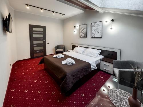 a bedroom with a bed and a red rug at Apartments On Zaliznychna 49 in Ivano-Frankivsʼk