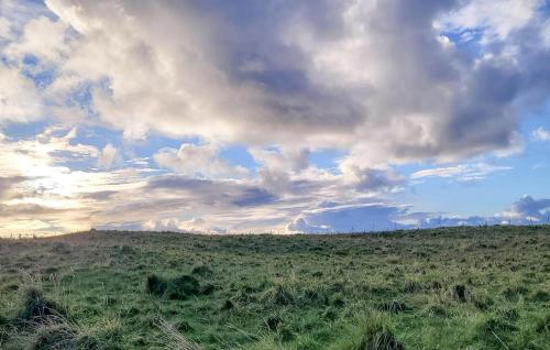 a large green field with a cloudy sky at Nice Apartment In Helgoland With Wifi in Helgoland