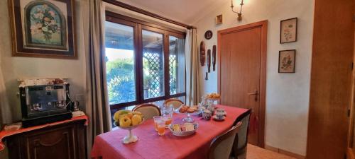 a dining room table with a red table cloth at B&B Le Amazzoni in Torre Chianca