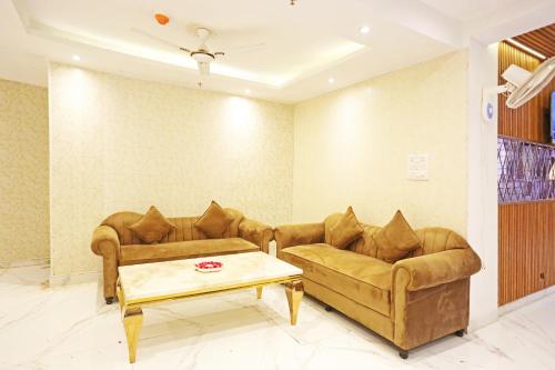 a living room with two couches and a coffee table at Hotel Mayfair Just a Minute Away From New Delhi Railway Station and Connaught place in New Delhi