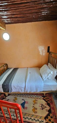a bed in a room with a wall at Ryad 91 in Casablanca