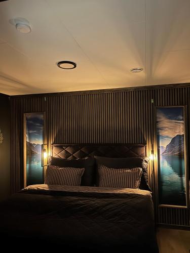 a bedroom with a bed with two posters on the wall at Lovely apartment in beautiful Loen in Loen