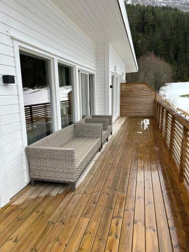 a porch with two couches on a wooden deck at Lovely apartment in beautiful Loen in Loen