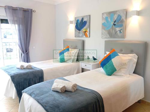 a bedroom with two beds with towels on them at Moradia Townhouse S Sebastião F in Guia