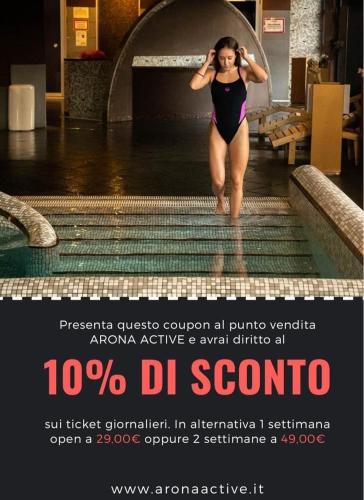 a woman in a swimsuit walking out of a swimming pool at Villa Ninfa Luxe in Arona