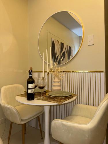 a table with a bottle of wine and a mirror at Quezon City Luxury Condo Unit Sun Residences Welcome Rotonda España in Manila