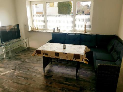 a living room with a couch with a coffee table at Apartment Bad Salzschlirf in Bad Salzschlirf