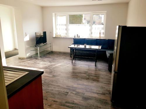 a living room with a blue couch and a table at Apartment Bad Salzschlirf in Bad Salzschlirf